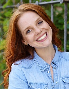 Woman smiling after Invisalign treatment