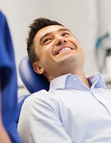 Man smiling during root canal therapy procedure