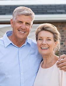 Older couple smiling after restorative dentistry 