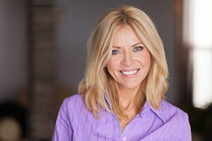 Woman in purple shirt smiling