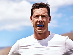 Closeup of man wearing blue mouthguard